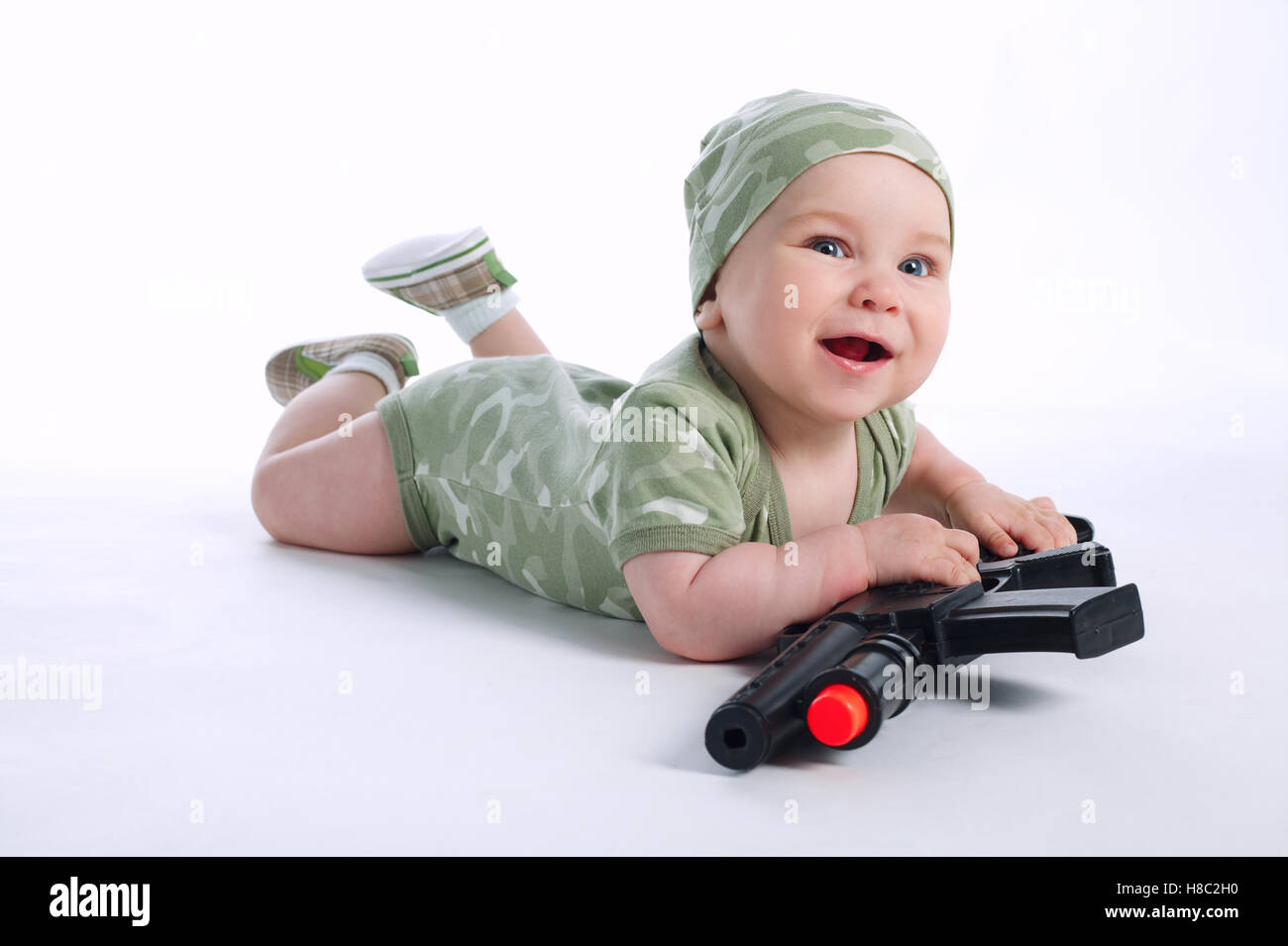 baby in khaki clothes with gun Stock Photo Alamy