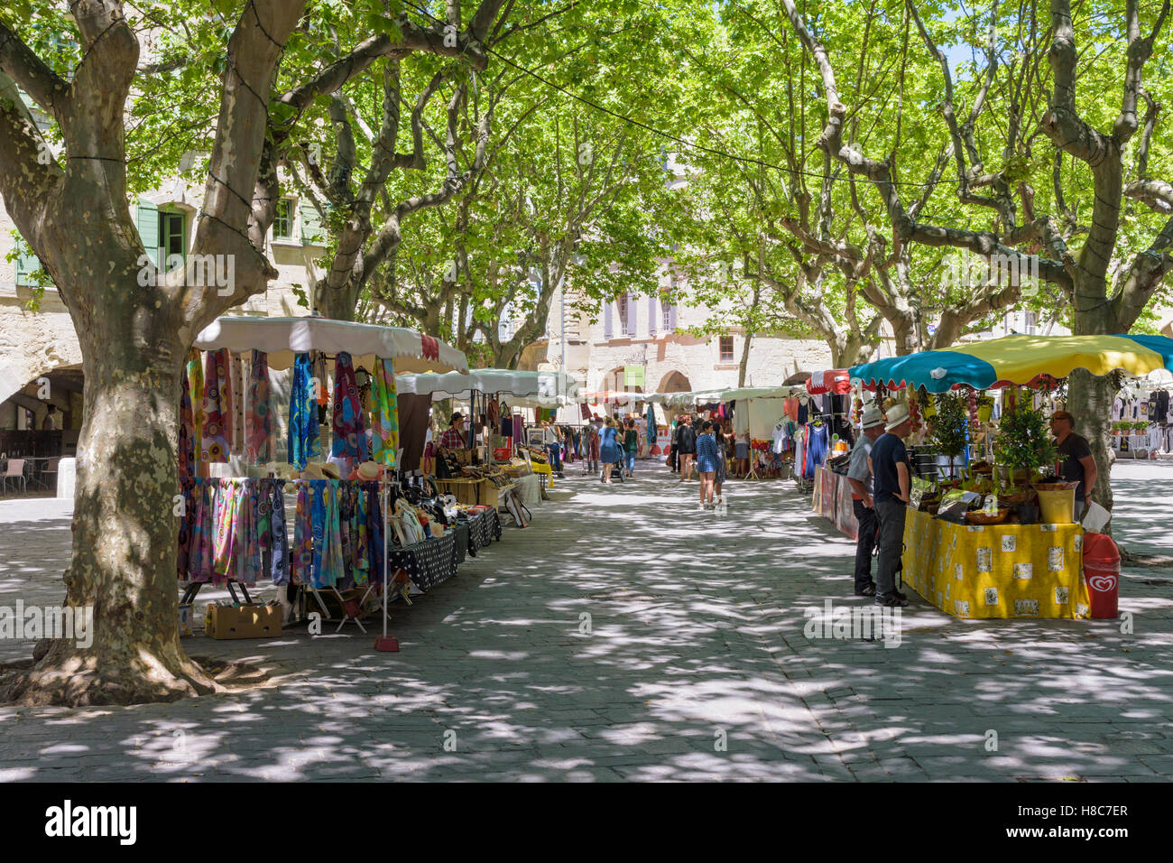 Tree shaded Place aux Herbes market in medieval Uzès town, Gard, France Stock Photo