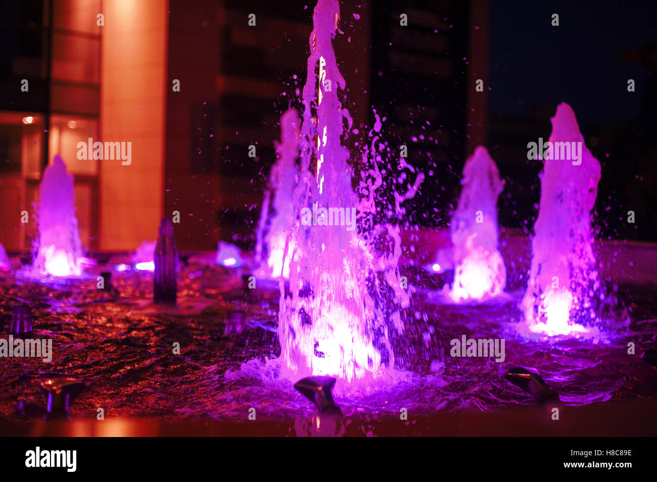 Illuminated colored night fountain in the city Stock Photo - Alamy