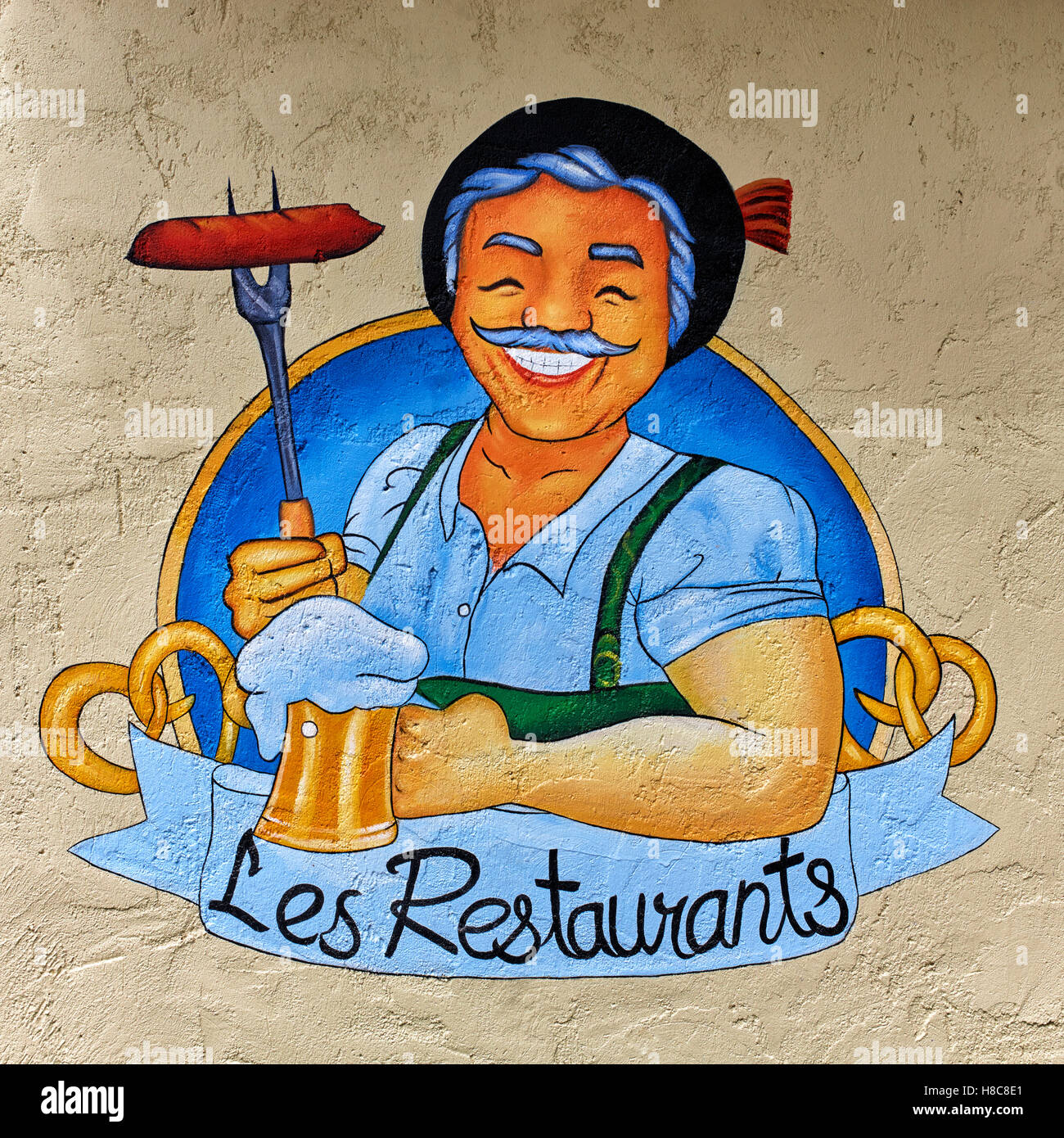 Restaurant wall art advertising with beaming and happy French host Stock Photo