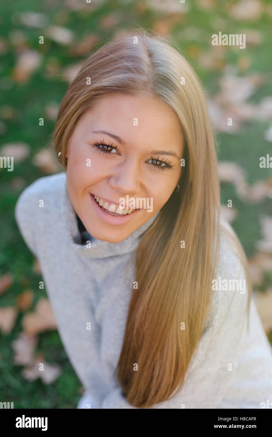 Pretty blonde girl in the park at autumn Stock Photo - Alamy