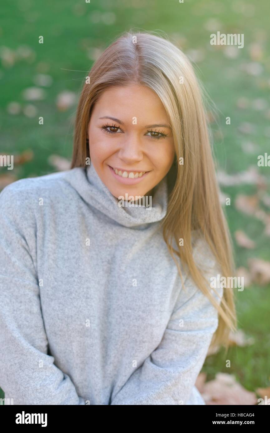 Pretty blonde girl in the park at autumn Stock Photo - Alamy
