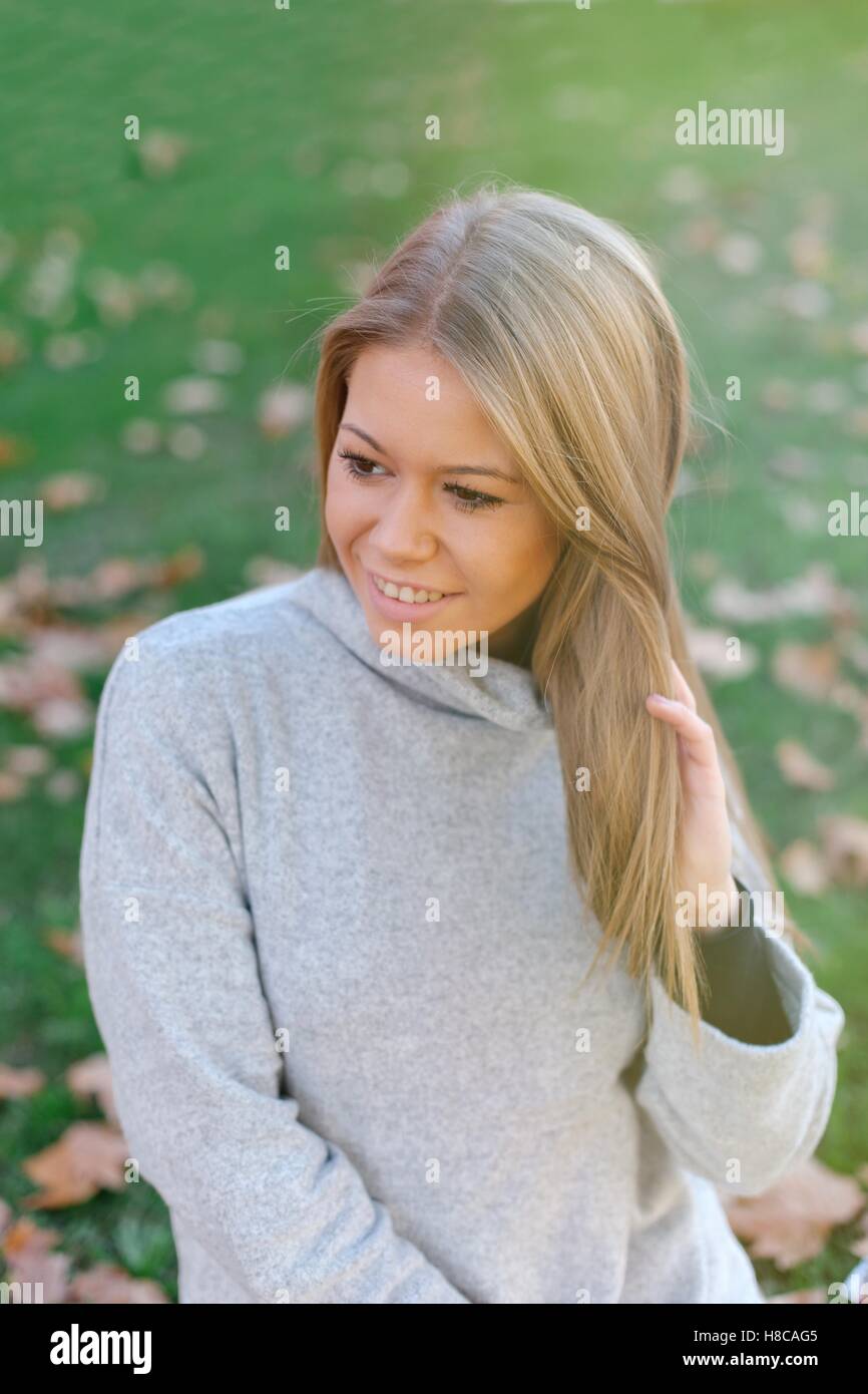 Pretty blonde girl in the park at autumn Stock Photo - Alamy
