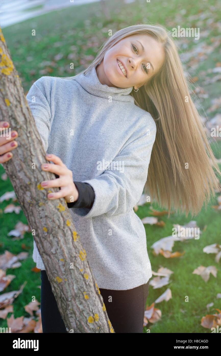 Pretty blonde girl in the park at autumn Stock Photo - Alamy