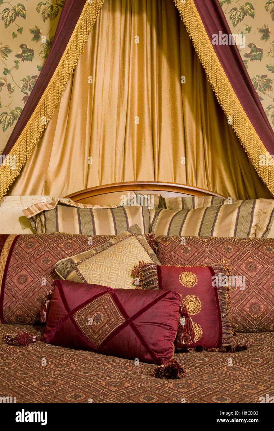 Double bed with gold curtains above headboard Stock Photo Alamy