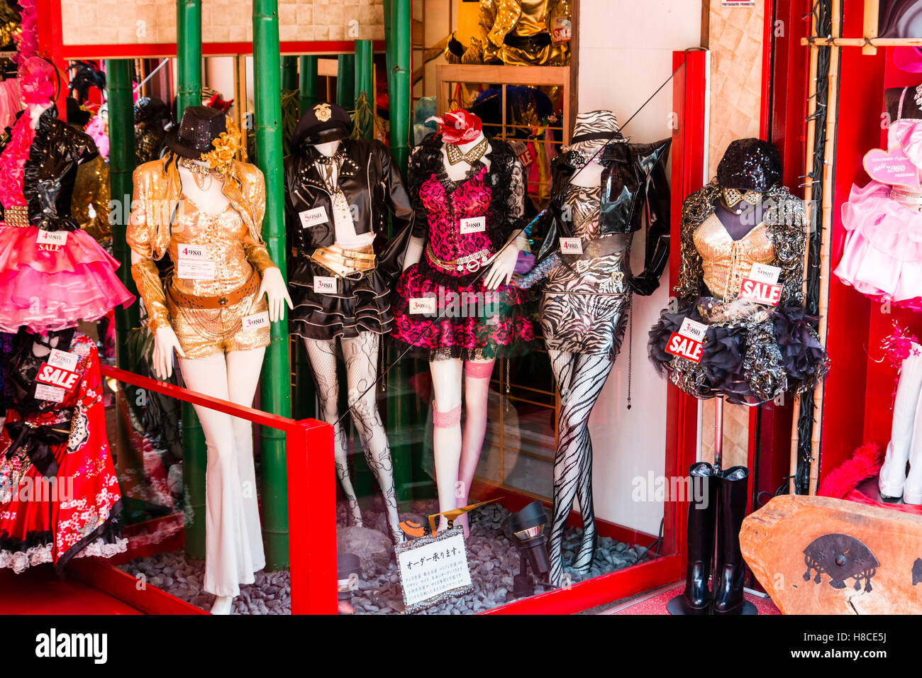 Japan, Tokyo, Harajuku, Takeshita-dori. BoutiqueTakenoko. Display of mannikins in gaudy glittery Lolita type costumes, price tag on each. Stock Photo