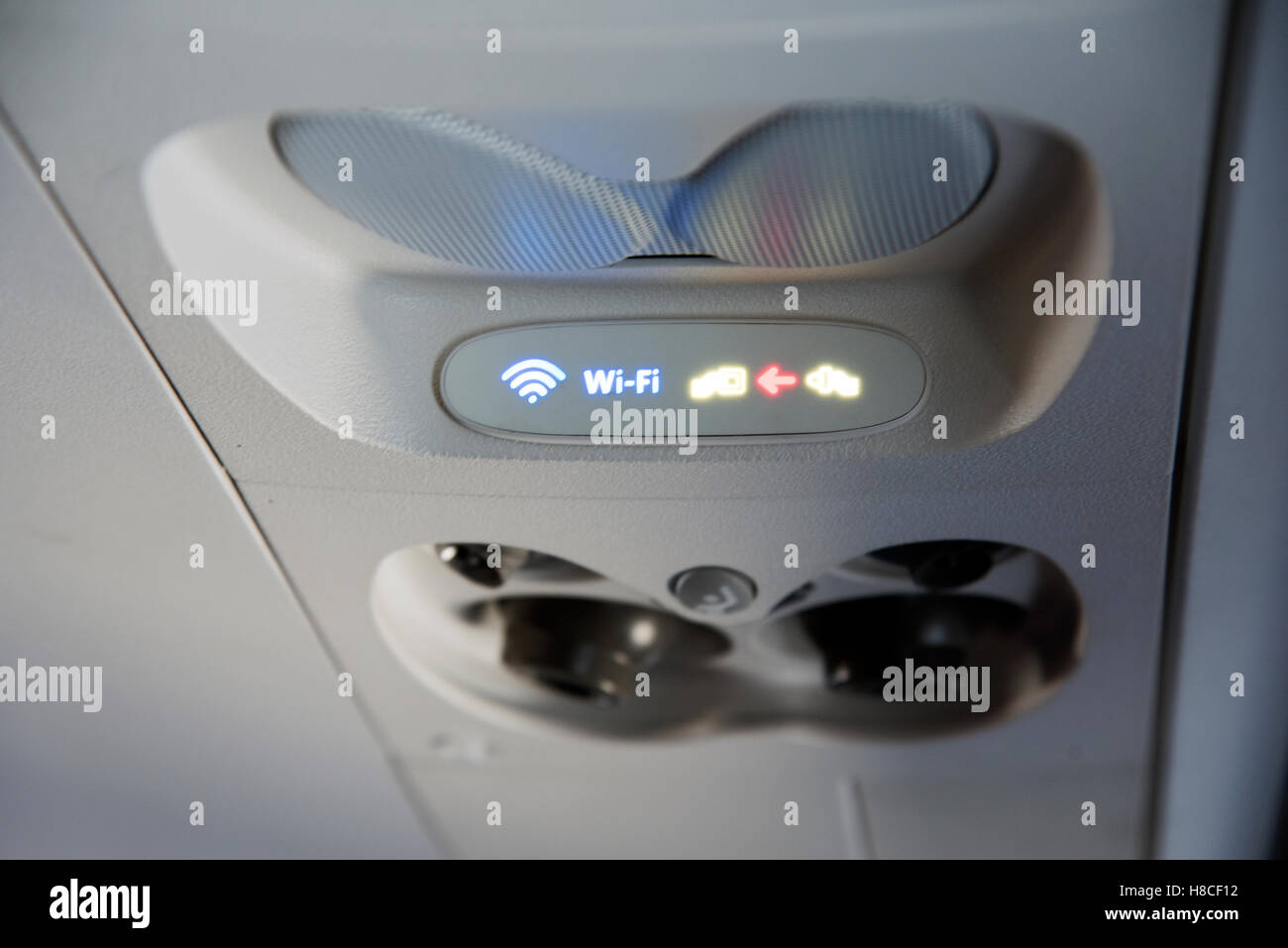 Wi-Fi and seatbelt signs on board a passenger jet Stock Photo