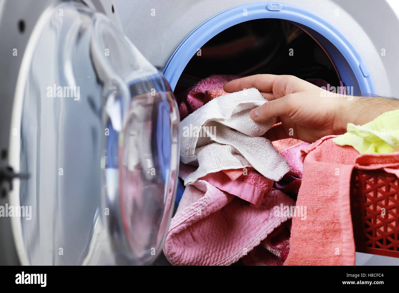 put cloth in washer Stock Photo Alamy