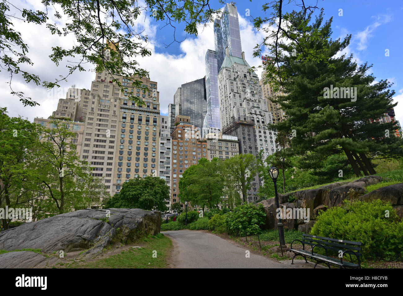 Path in New York City's Central Park with rocks, trees and skyscrapers