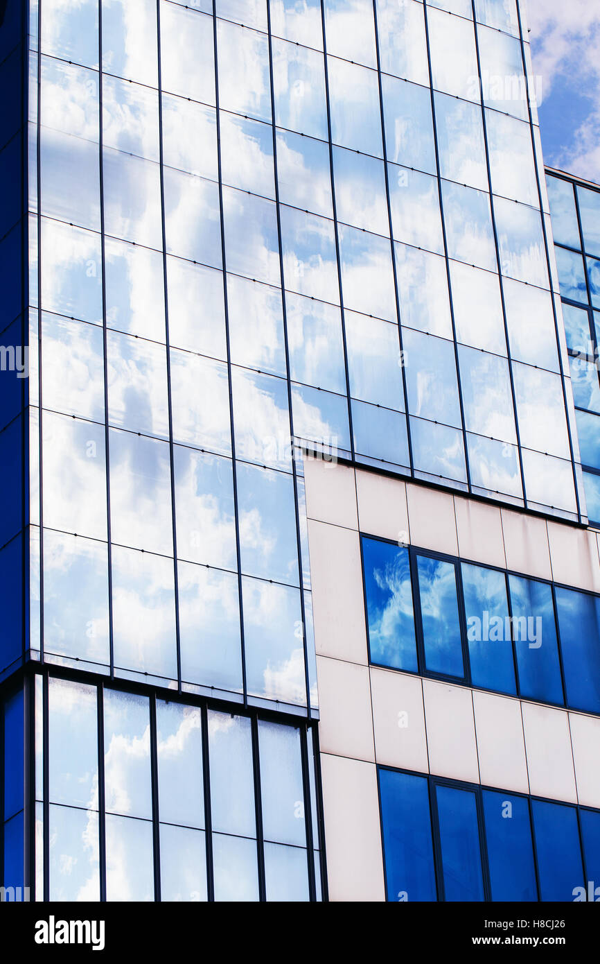 Clouds reflected in windows of modern office building Stock Photo - Alamy