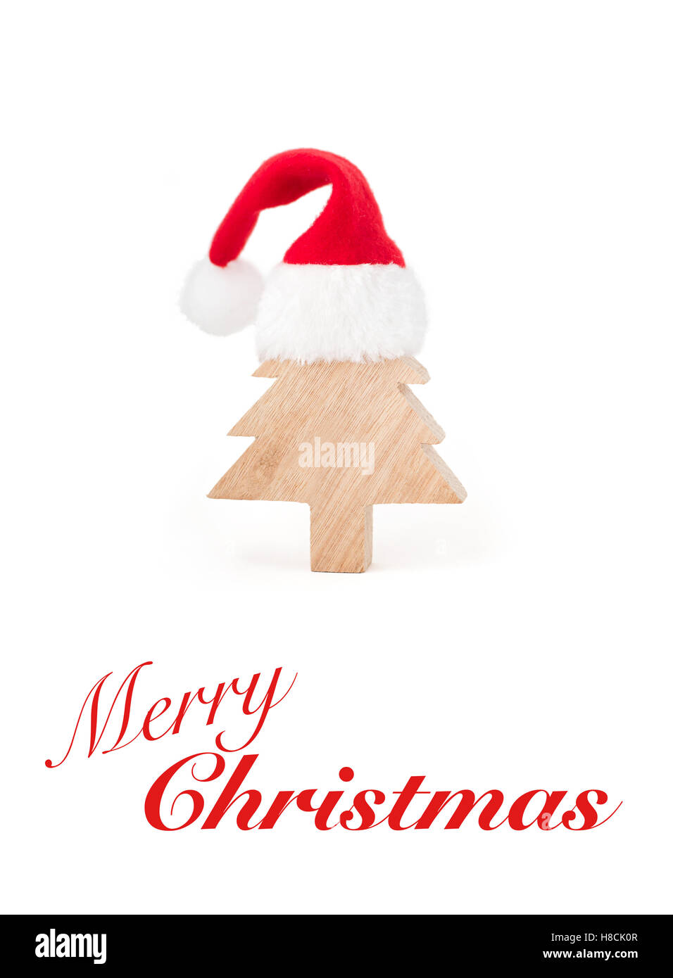Cute Merry Christmas greeting card with a wooden christmas tree and red hat Stock Photo