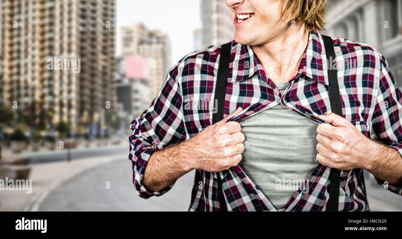 Composite image of funny blond hipster taking off his shirt Stock Photo
