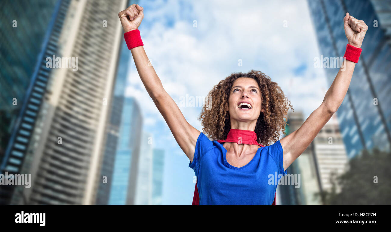 Composite image of woman pretending to be superhero Stock Photo