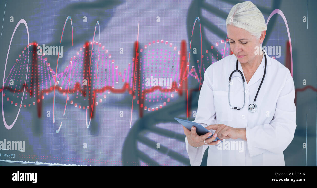 Composite image of female doctor using table computer Stock Photo