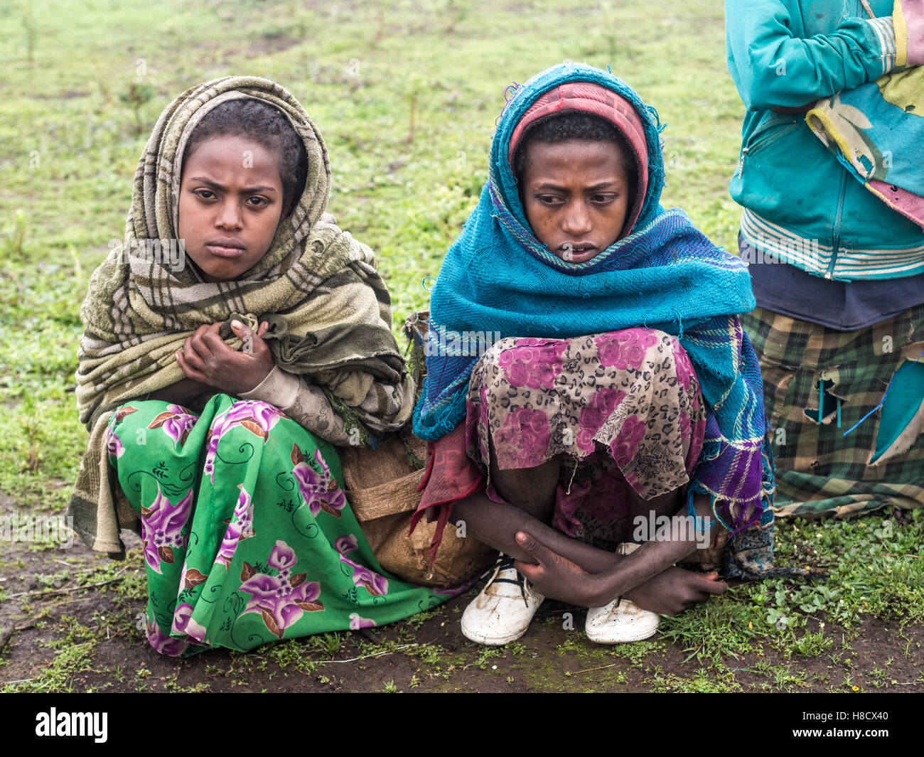 Girls selling souvenirs in Semien Mountains, Ethiopia, on a foggy day. Stock Photo