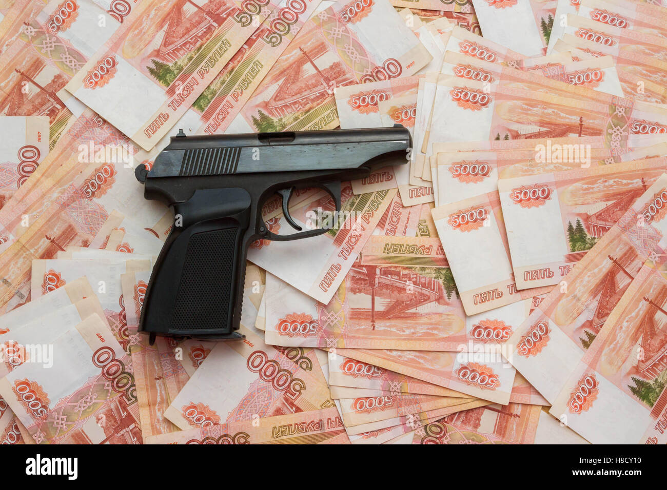 Black gun lies on the Russian big money Stock Photo