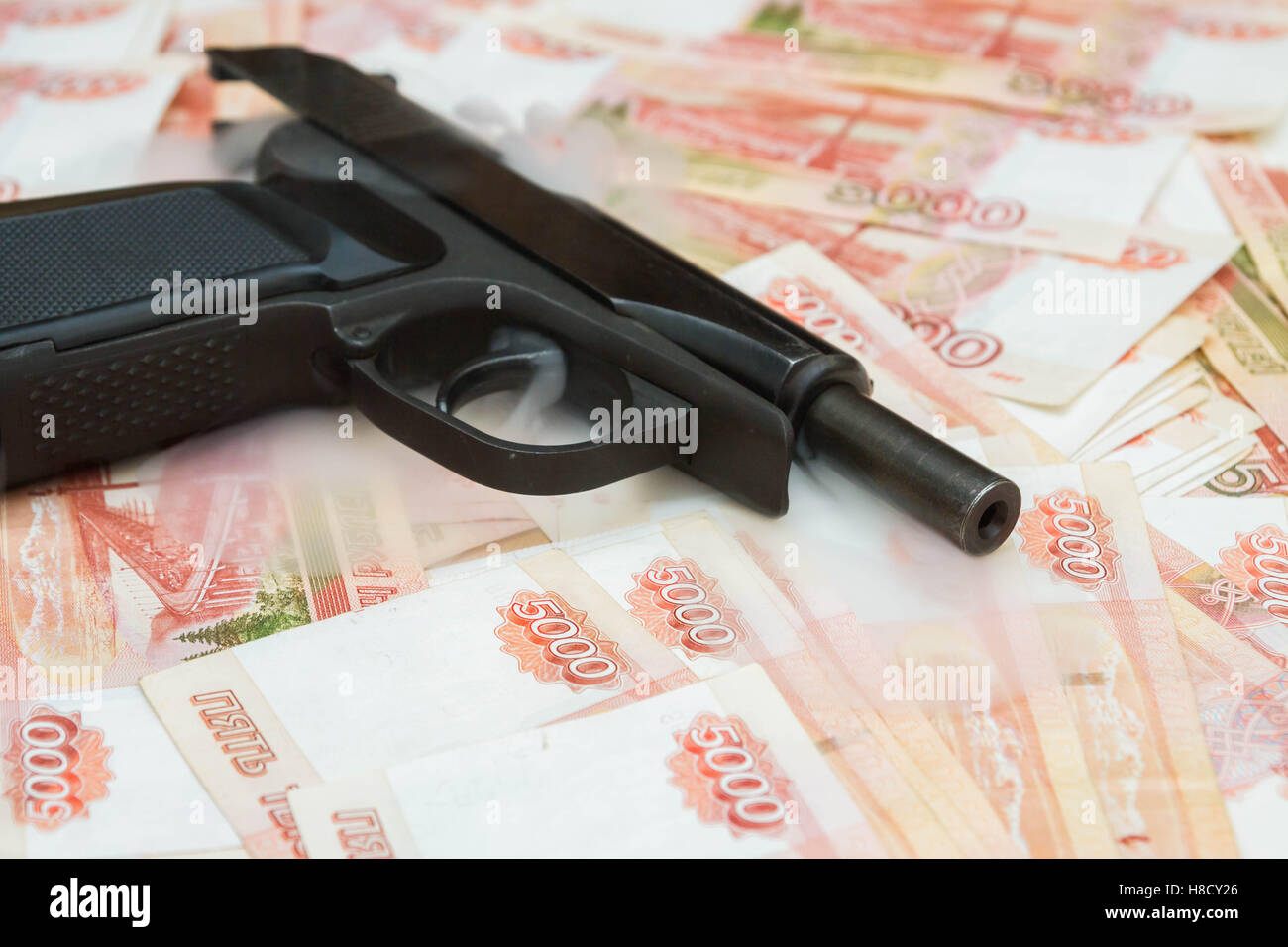 Black gun lies on the Russian big money Stock Photo