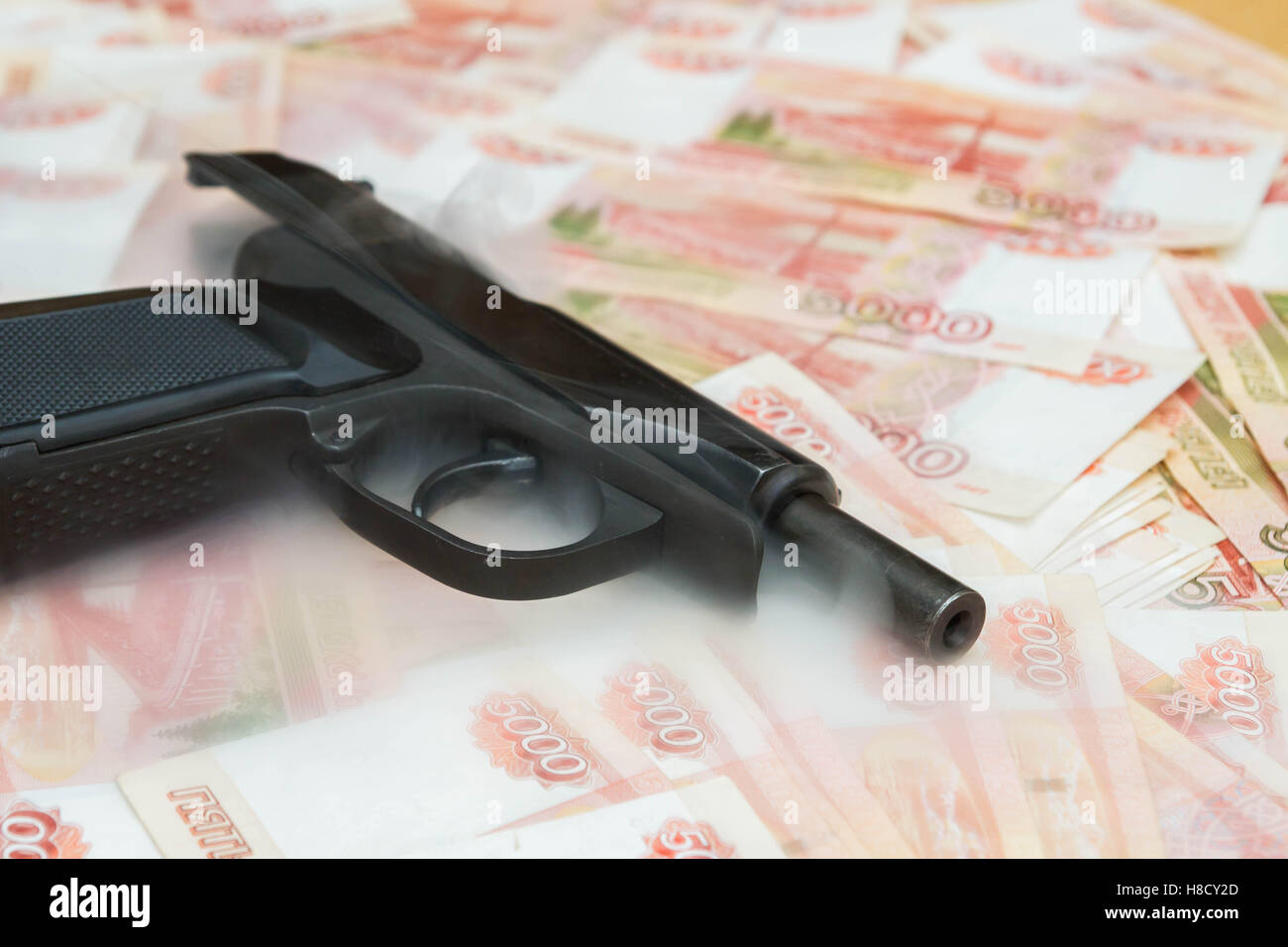 Black gun lies on the Russian big money Stock Photo