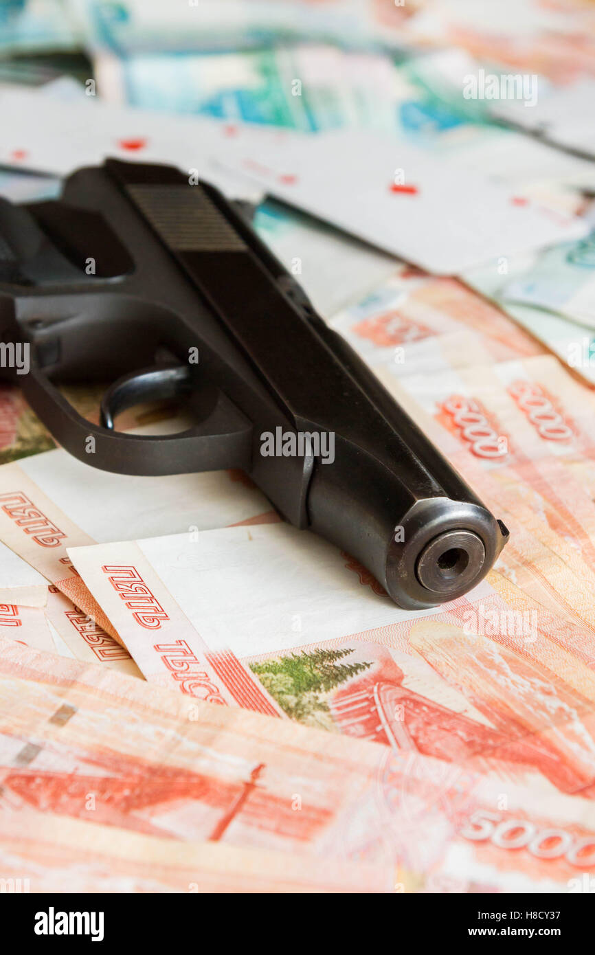 Black gun lies on the Russian big money Stock Photo