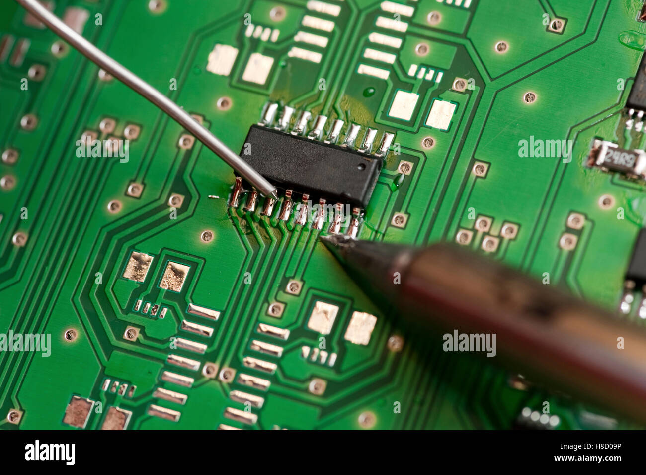 Soldering an electronic component on a printed circuit board Stock Photo