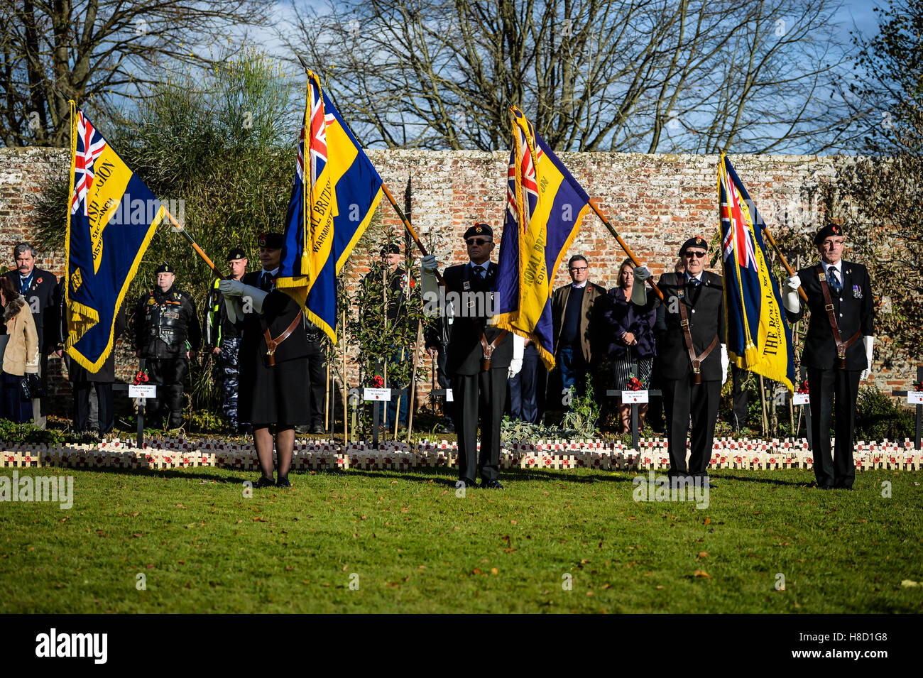 Royal British Legion standard bearers lower their flags during a service for the opening of the Field of Remembrance at Royal Wootton Bassett, near Swindon. Stock Photo