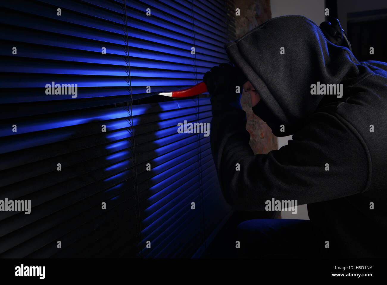 Thief tries to open window Stock Photo - Alamy