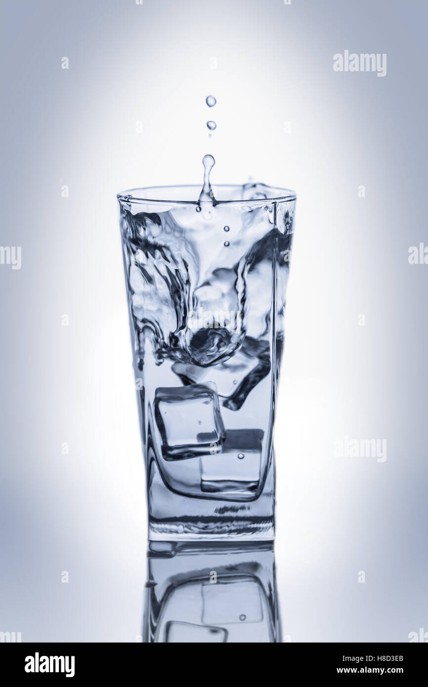 glass of water with ice cubes and a splash Stock Photo - Alamy