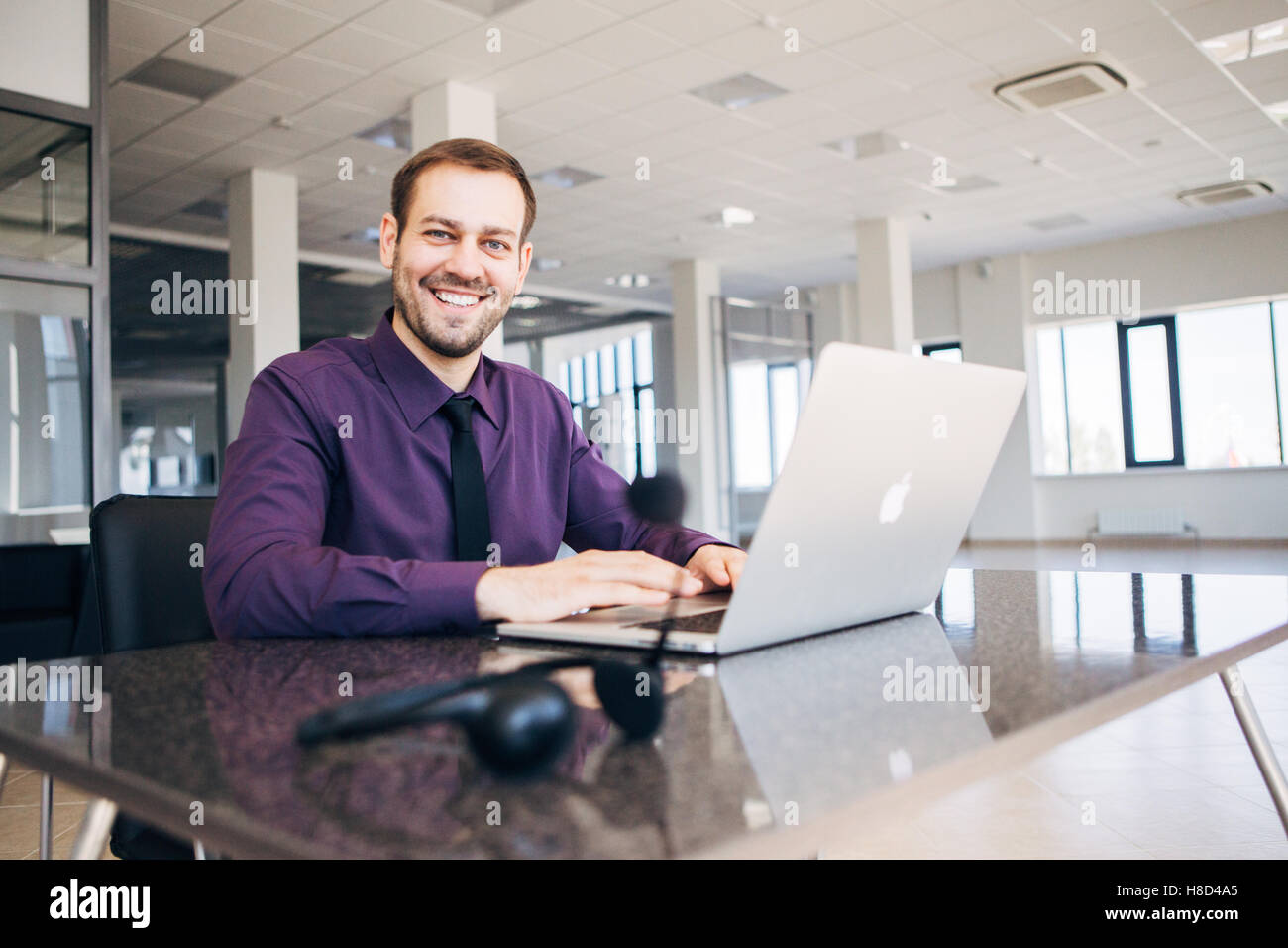 happy man working as an operator in the center of the number Stock Photo