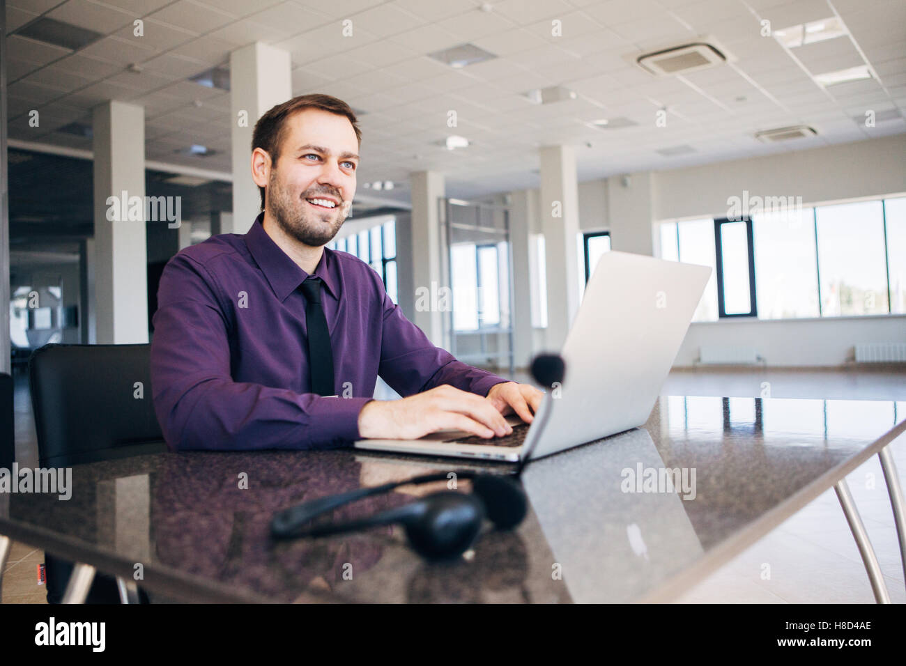 happy man working as an operator in the center of the number Stock ...