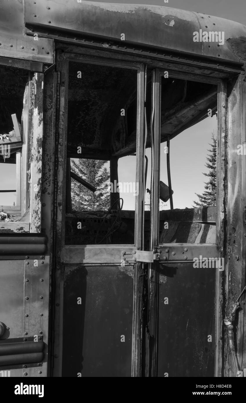 Burned out school bus door ready to be opened for students Stock Photo