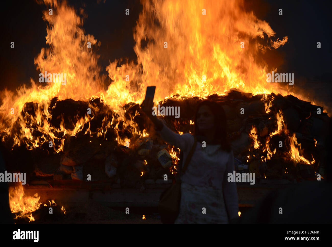 Lahore, Pakistan. 10th Nov, 2016. Pakistani paramilitary soldiers, anti-narcotics Control Forces (ANF) burn a pile of seized drugs smashed bottles liquor. Pakistani authorities torched tonnes of seized drugs like heroin, hashish, cocaine, liquor and opium during an annual drug burning ceremony attended by anti-narcotics and other officials. Pakistan annually seizes huge quantities of drugs which straddle a route from neighboring Afghanistan, destined for lucrative markets in the Middle East. Credit:  Rana Sajid Hussain/Pacific Press/Alamy Live News Stock Photo