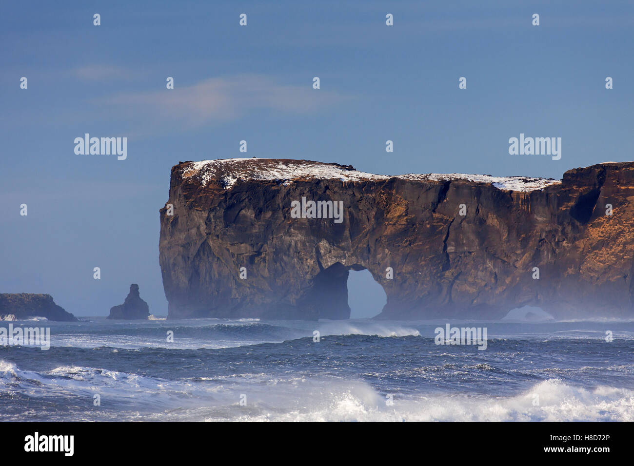 Black arch of lava near Vík í Mýrdal at the Dyrhólaey peninsula in winter, south coast of Iceland Stock Photo