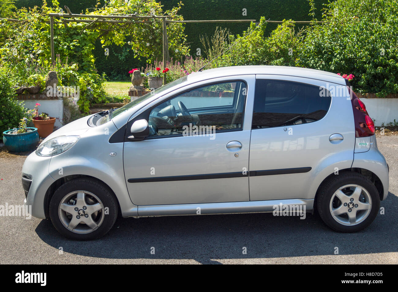 A small Peugeot 107 saloon car showing its side view Stock Photo