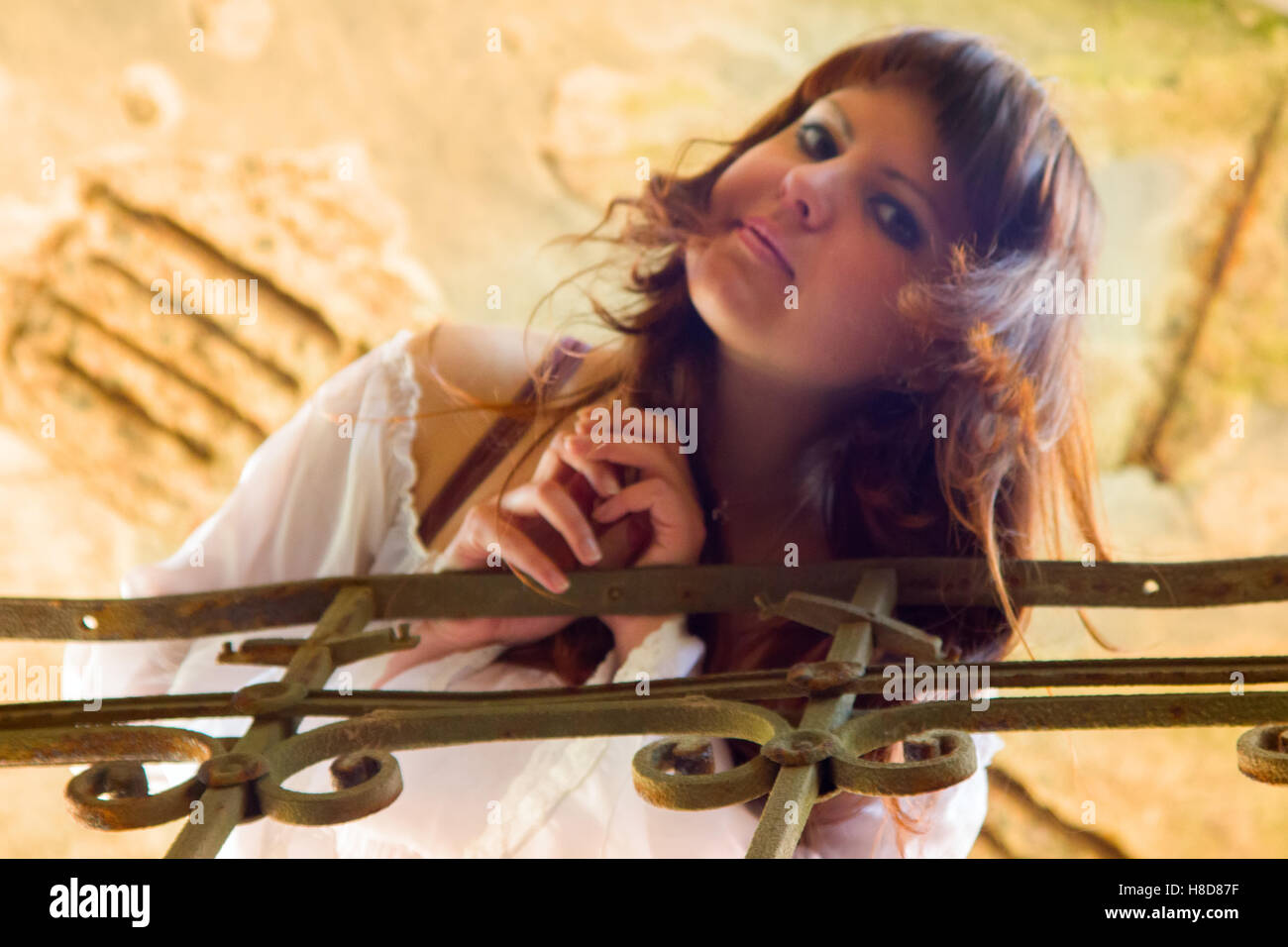 Beautiful woman on a stairs. girl looks down at you Stock Photo - Alamy