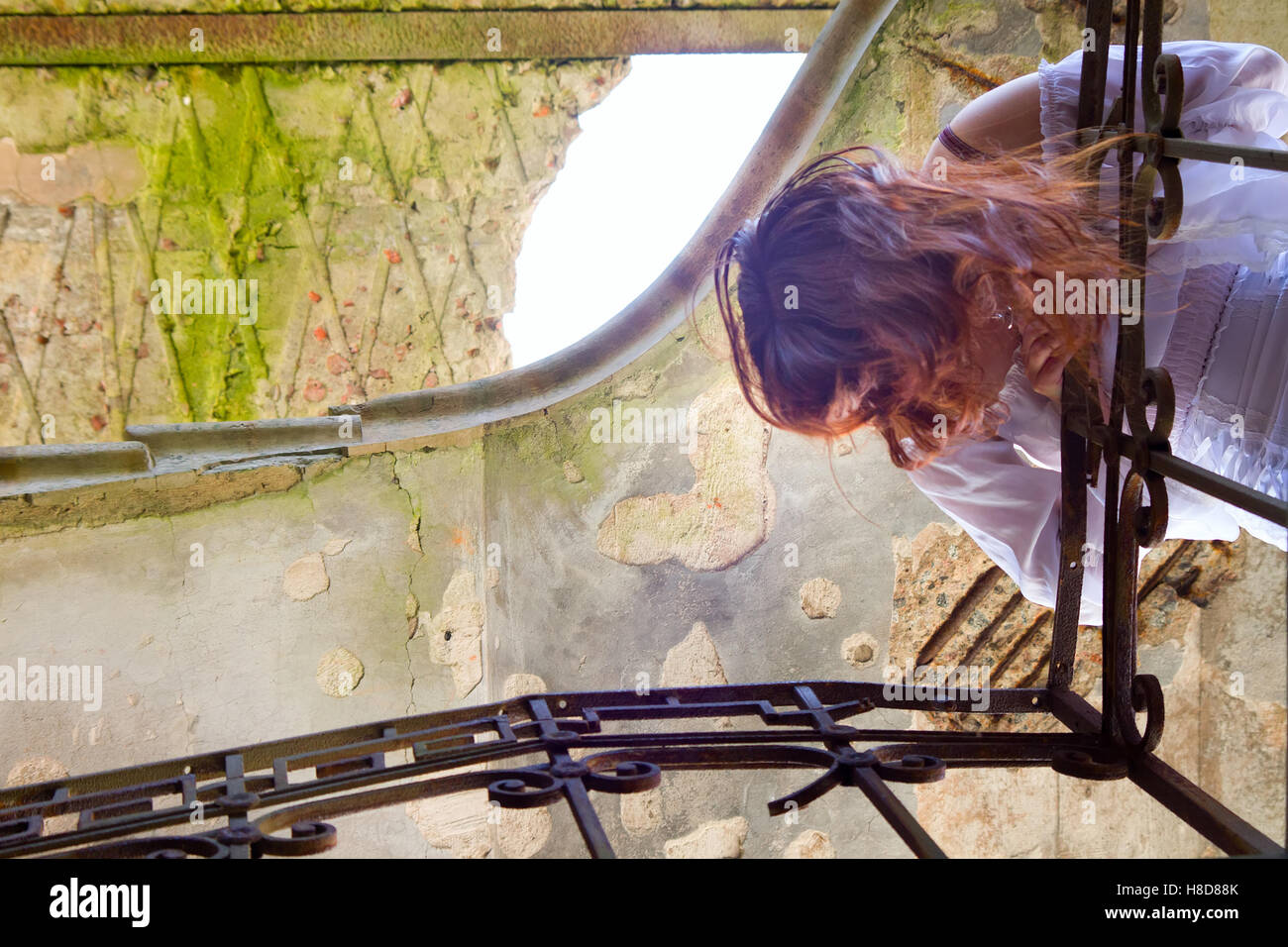 Beautiful woman on a stairs. girl looks down at you Stock Photo - Alamy