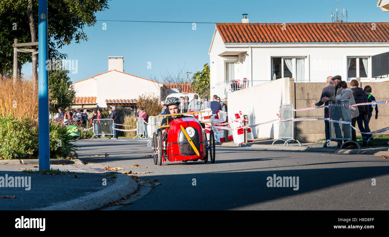 Bretignolles sur Mer, France - October 29, 2016 : old pedal car race organized in city street. Participants are dressed in the c Stock Photo