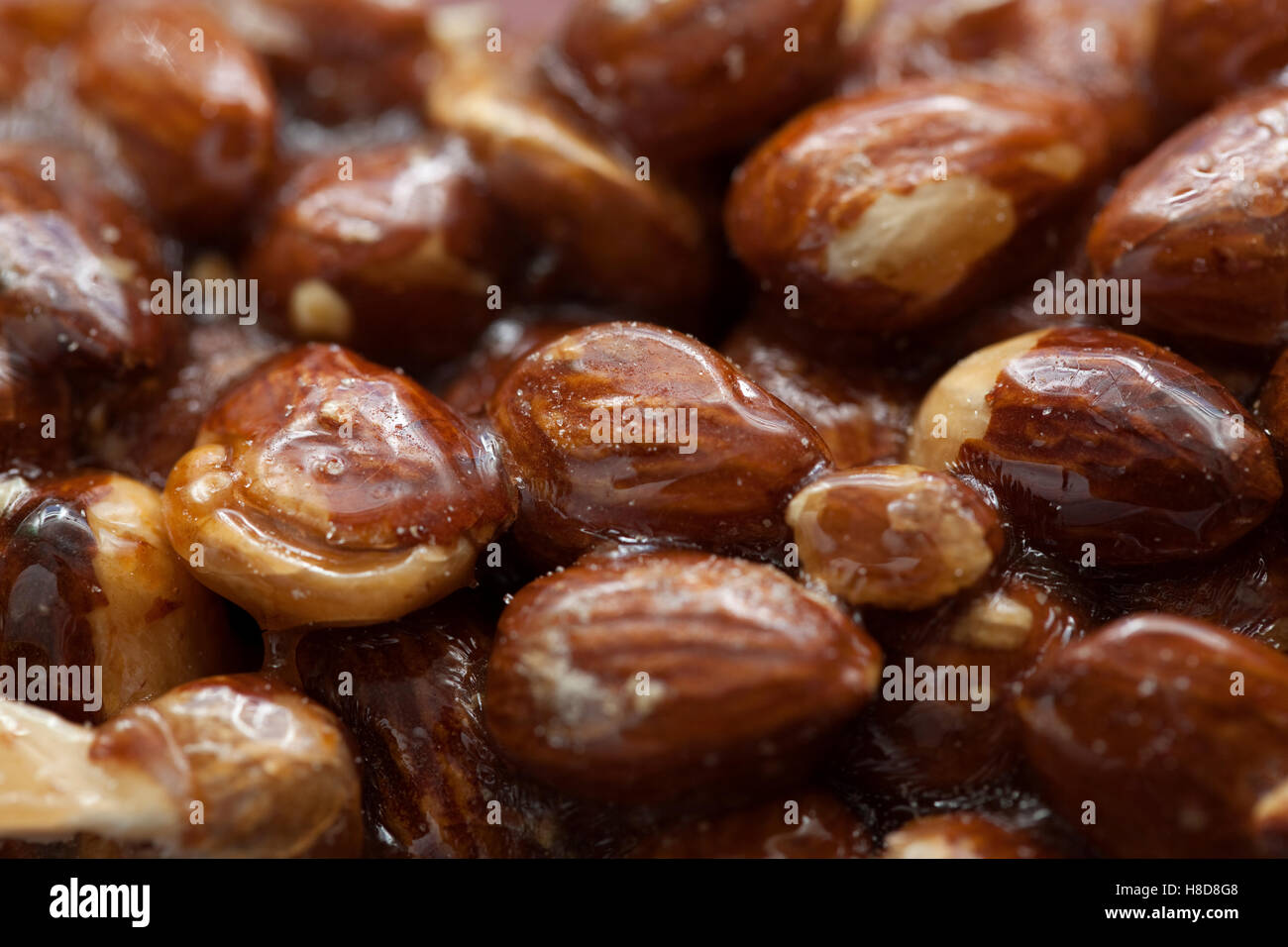 the whole almonds in caramel as background Stock Photo