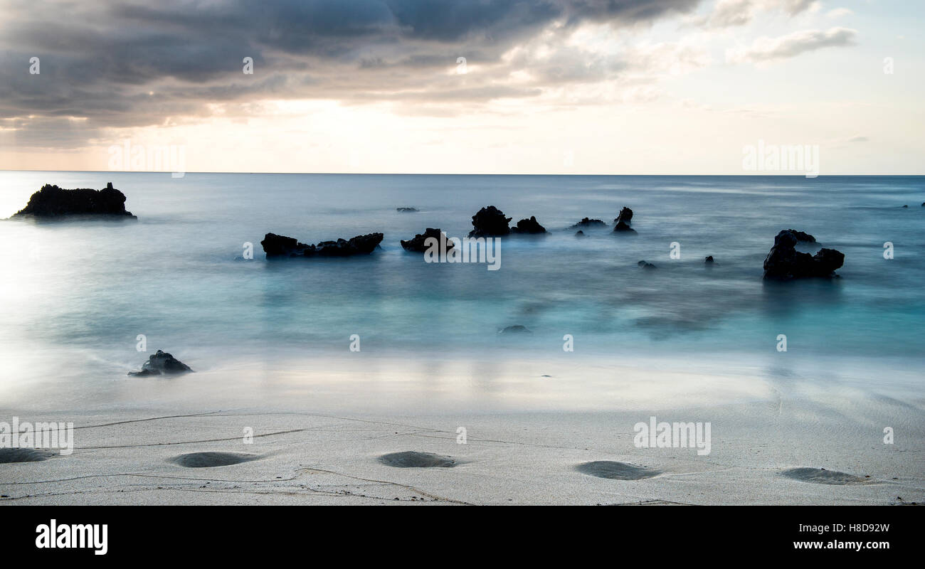 Ascension Island.   Rocks at Dead Man's Beach Georgetown at sunset artistic long exposure Stock Photo