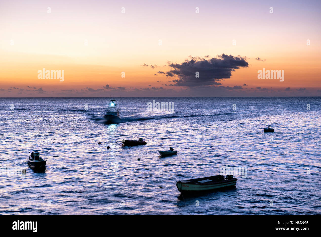 Sports fishing  boat trip returns at sunset to the wharf at Georgetown Ascension Island Stock Photo