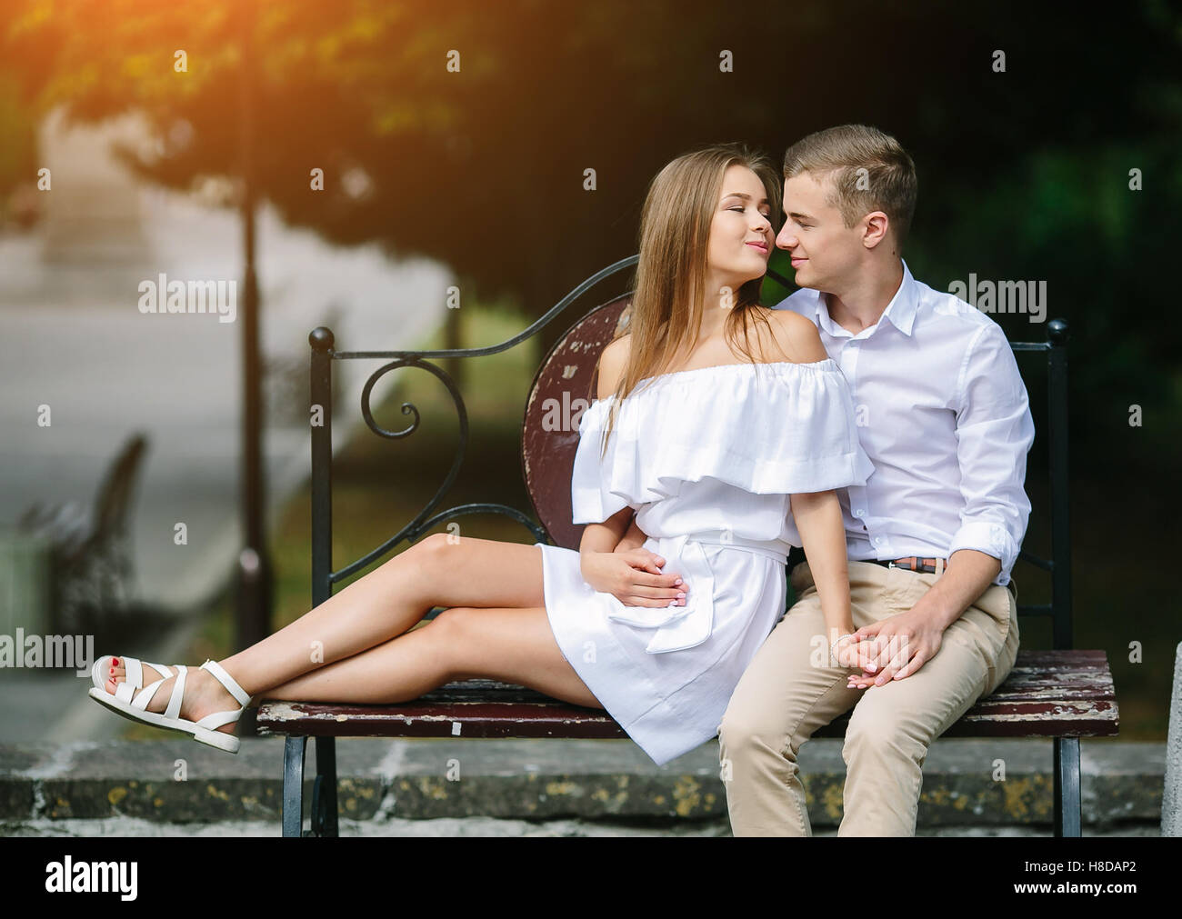man and woman on a bench in the park Stock Photo - Alamy