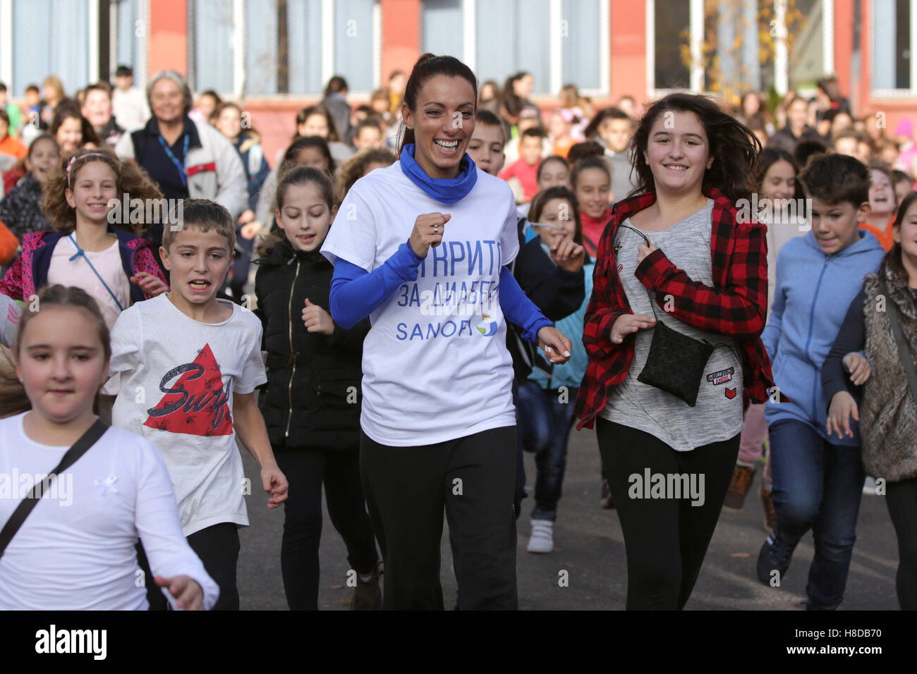 Sofia, Bulgaria - November 10, 2016: Bulgarian athlete Ivet Lalova-Collio is running with children in Sofia's 119's school playg Stock Photo