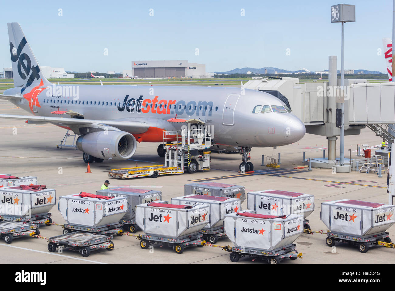 Baggage trucks and Jetstar aircraft at Brisbane Airport Stock Photo Alamy
