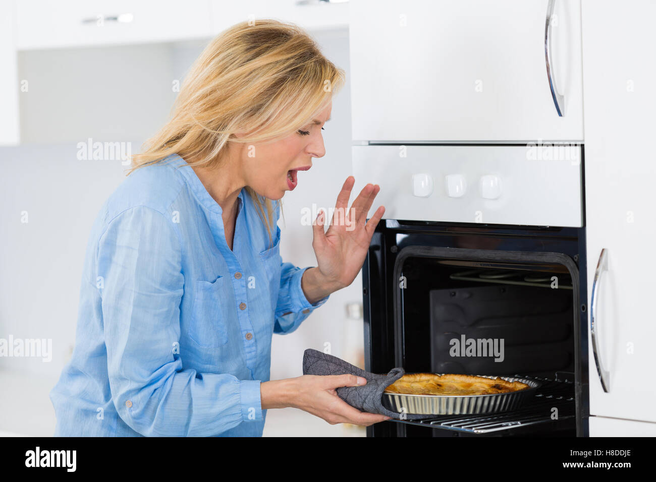 kitchen burn on hand caused by heating oven Stock Photo