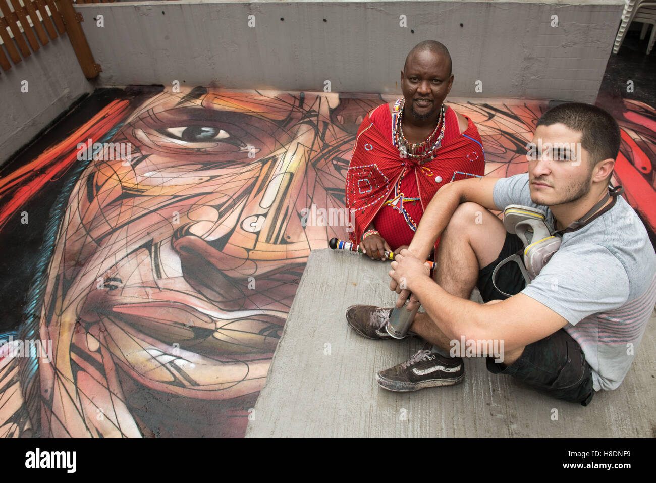Hong Kong, Hong Kong S.A.R, China. 10th Nov, 2016. Rooftop painting by Parisian street artist Alexandre Monteiro aka Hopare (R) of Masai warrior Daniel Ole Sambu (L).Street art in Hong Kong ahead of the The 'Hope for Wildlife' Gala Dinner painted to raise awareness for the plight of endangered animals the world over.Sheung Wan Hong Kong.10th November 2016. Photo by Jayne Russell. © Jayne Russell/ZUMA Wire/Alamy Live News Stock Photo