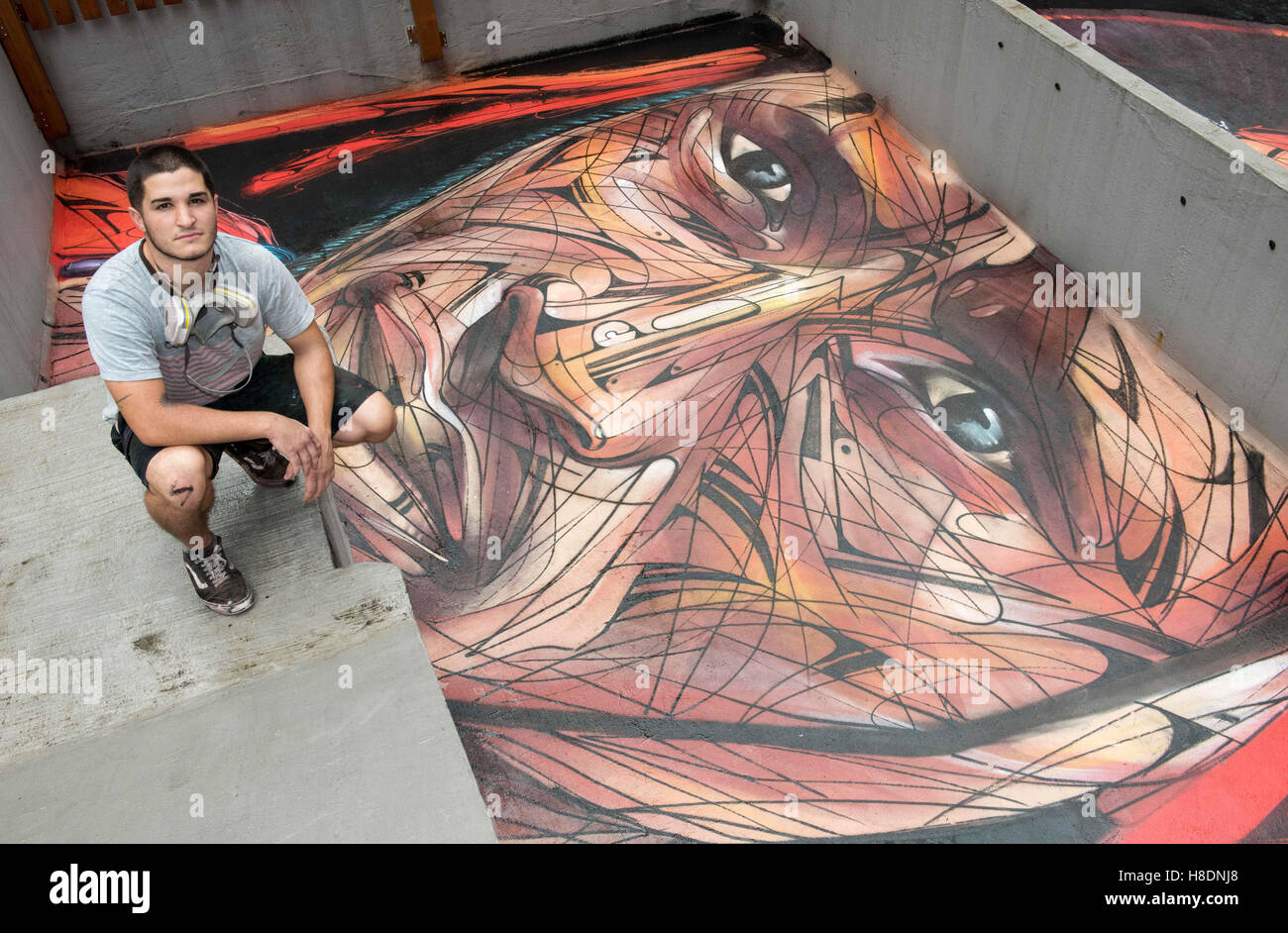 Hong Kong, Hong Kong S.A.R, China. 10th Nov, 2016. Rooftop painting by Parisian street artist Alexandre Monteiro aka Hopare (pictured)of Masai warrior Daniel Ole Sambu, .Street art in Hong Kong ahead of the The 'Hope for Wildlife' Gala Dinner painted to raise awareness for the plight of endangered animals the world over.Sheung Wan Hong Kong.10th November 2016. Photo by Jayne Russell. © Jayne Russell/ZUMA Wire/Alamy Live News Stock Photo