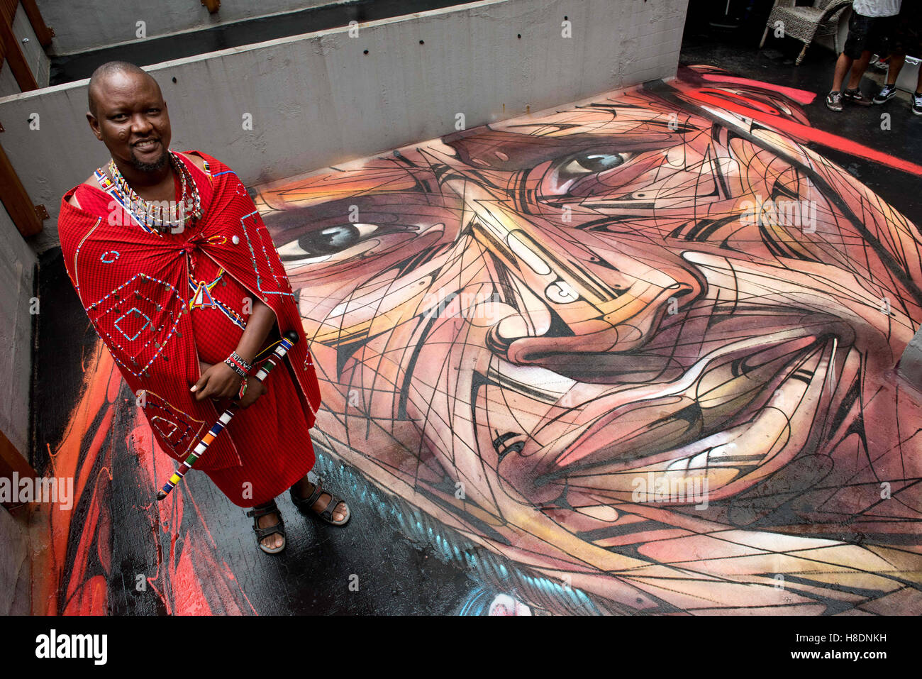 Hong Kong, Hong Kong S.A.R, China. 10th Nov, 2016. Rooftop painting by Parisian street artist Alexandre Monteiro aka Hopare of Masai warrior Daniel Ole Sambu (Pictured).Street art in Hong Kong ahead of the The 'Hope for Wildlife' Gala Dinner painted to raise awareness for the plight of endangered animals the world over.Sheung Wan Hong Kong.10th November 2016. Photo by Jayne Russell. © Jayne Russell/ZUMA Wire/Alamy Live News Stock Photo
