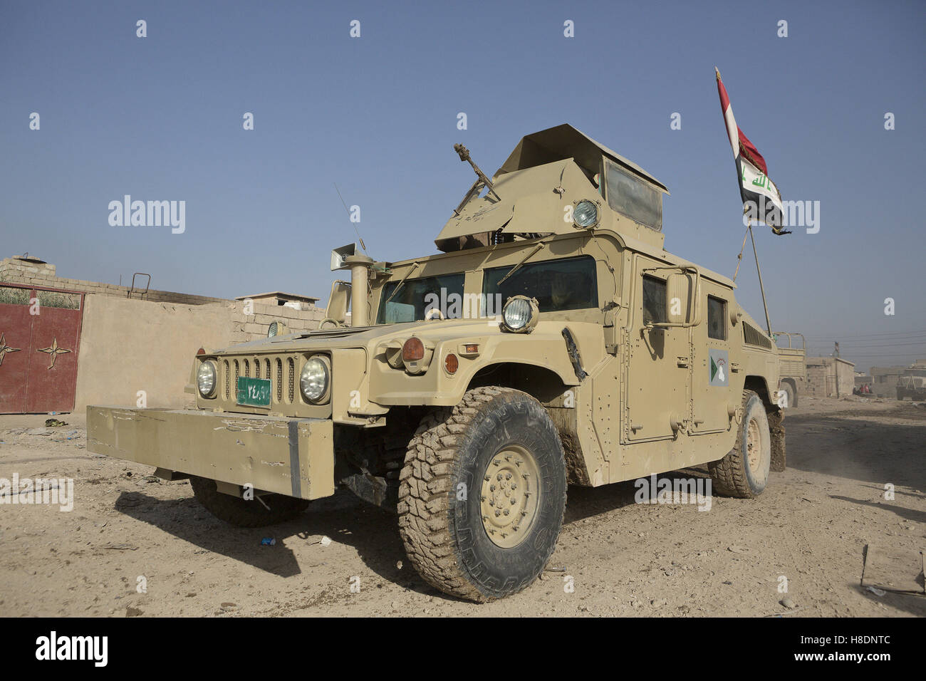 Mosul, Nineveh, Iraq. 11th Nov, 2016. 11/11/2016. Mosul, Iraq. An armoured Humvee, belonging to the Iraqi Army's 9th Armoured Division, drives through Mosul's Hay Intisar district on the south east of the city. The district was taken by Iraqi Security Forces (ISF) around a week ago and, despite its proximity to ongoing fighting between ISF and ISIS militants, many residents still live in the settlement. Credit:  ZUMA Press, Inc./Alamy Live News Stock Photo