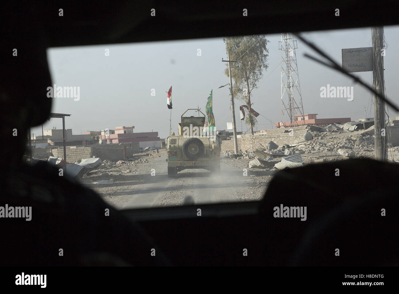 Mosul, Nineveh, Iraq. 11th Nov, 2016. 11/11/2016. Mosul, Iraq. An Iraqi Army armoured Humvee, belonging to the Iraqi 9th Armoured Division, is seen through bullet proof windscreen as an Iraqi Army convoy travels through a suburb of Mosul, Iraq. Credit:  ZUMA Press, Inc./Alamy Live News Stock Photo