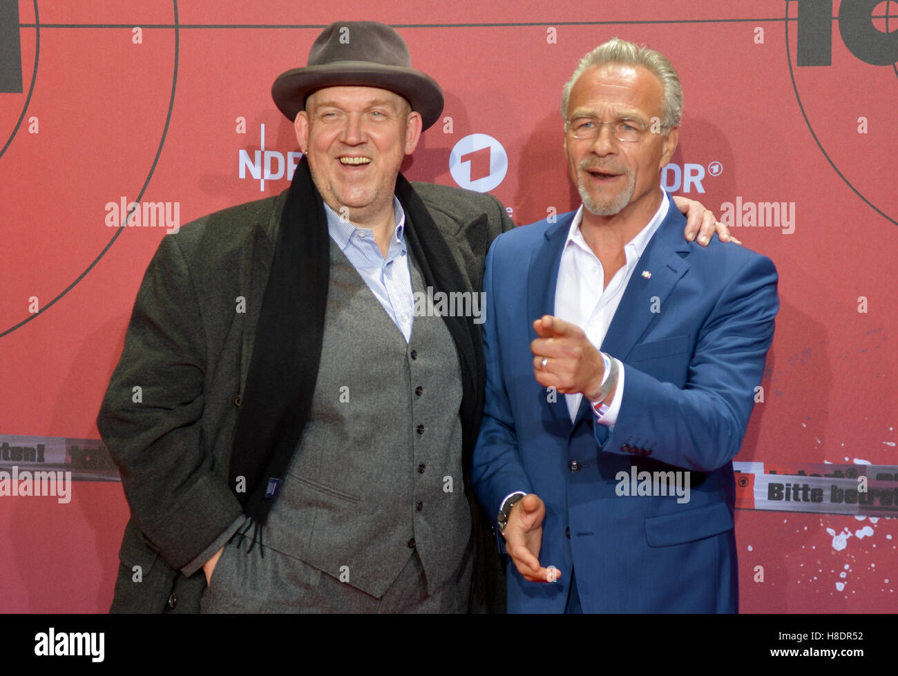 Actors Klaus J. Behrendt (r) and Dietmar Baer walk across the red carpet in front of the Cinemax cinema in Hamburg, Germany, 11 Novewmber 2016. The ARD celebrates the 1000th episode of Tatort with a presentation of the anniversary episode and a 'Tatort Lounge' party with numerous 'inspectors'. PHOTO: AXEL HEIMKEN/dpa Stock Photo