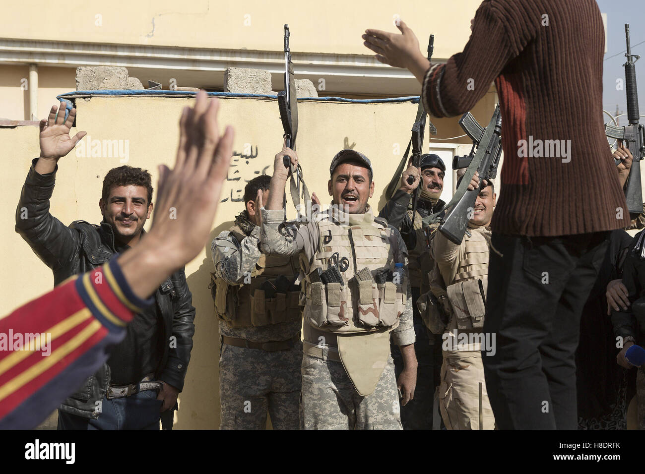 Mosul, Nineveh, Iraq. 11th Nov, 2016. Residents and Iraqi soldiers dance to music during a visit to Mosul's Al Antisar district by soldiers of the Iraqi Army's 9th Armoured Division. The Al Intisar district was taken four days ago by Iraqi Security Forces (ISF) and, despite its proximity to ongoing fighting between ISF and ISIS militants, many residents still live in the settlement without regular power and water and with dwindling food supplies. © Matt Cetti-Roberts/ZUMA Wire/Alamy Live News Stock Photo